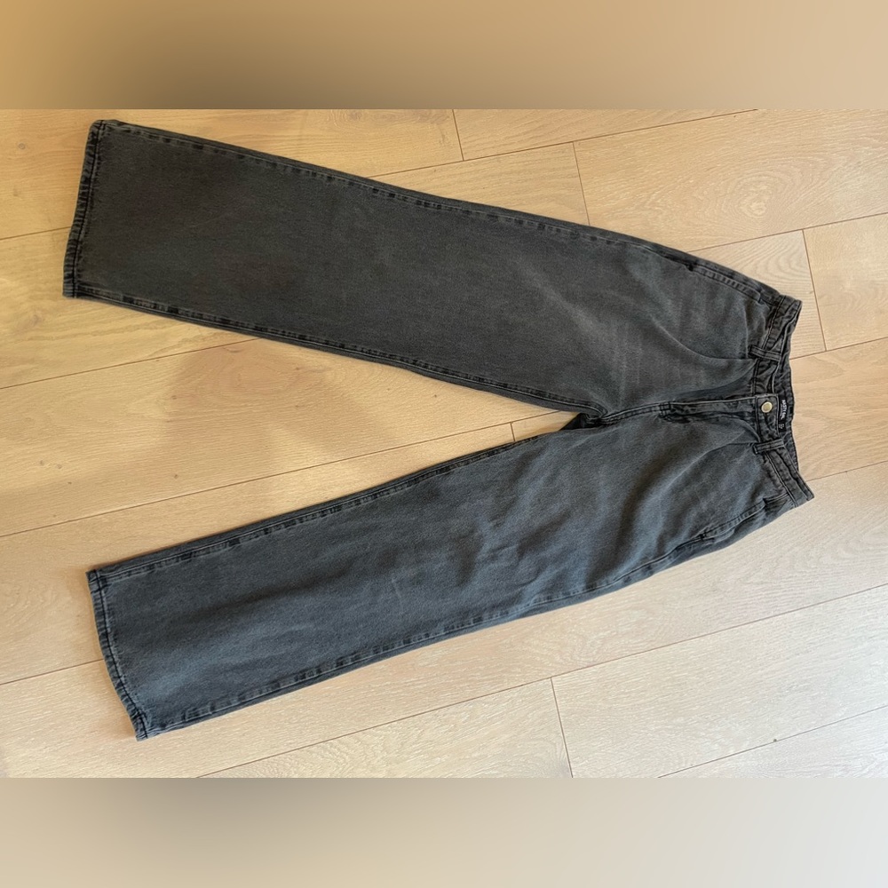 Straight leg, low rise, dark gray denim jeans.